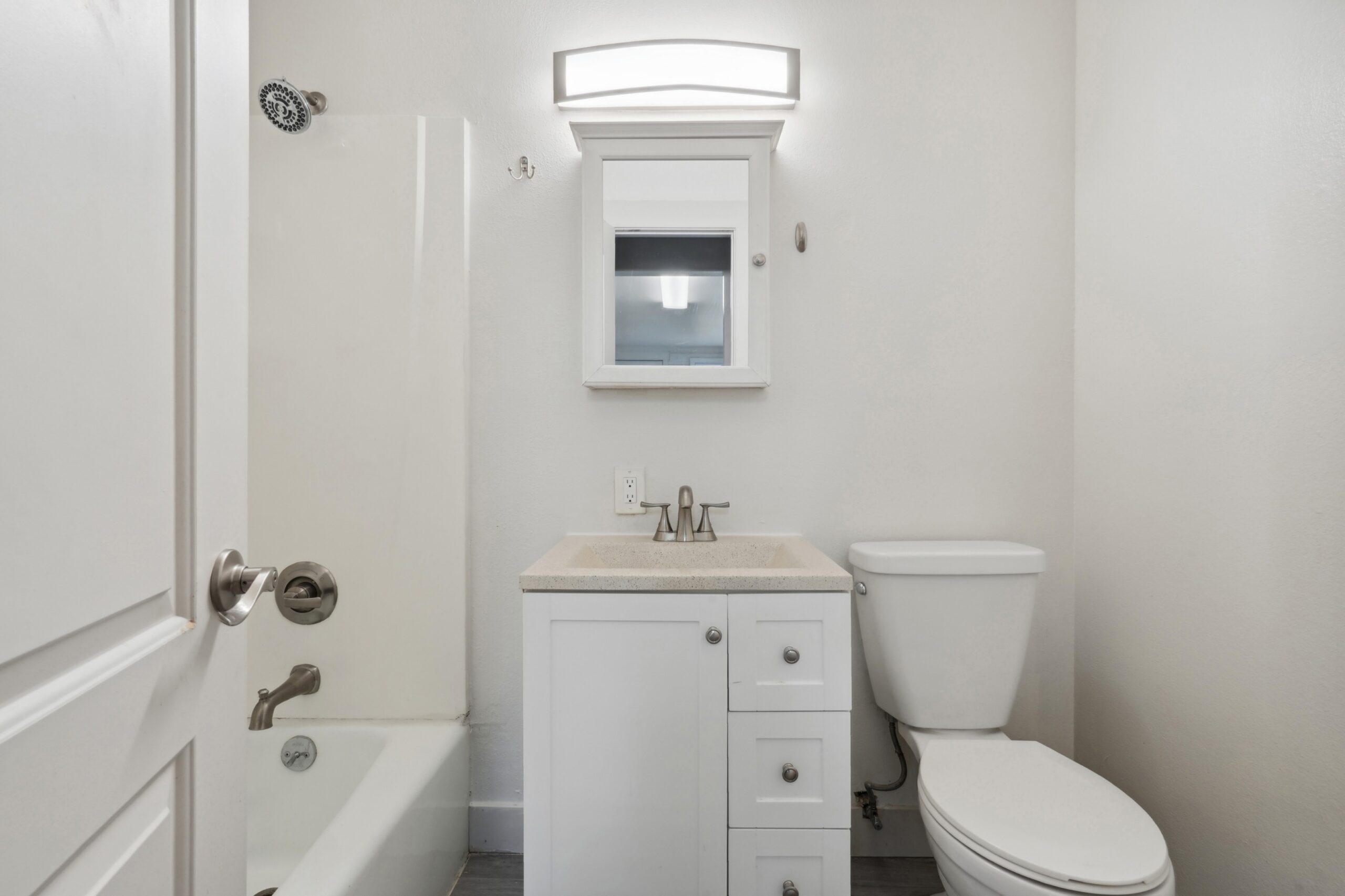 Bathroom with combination tub shower at Flats on 2nd scaled