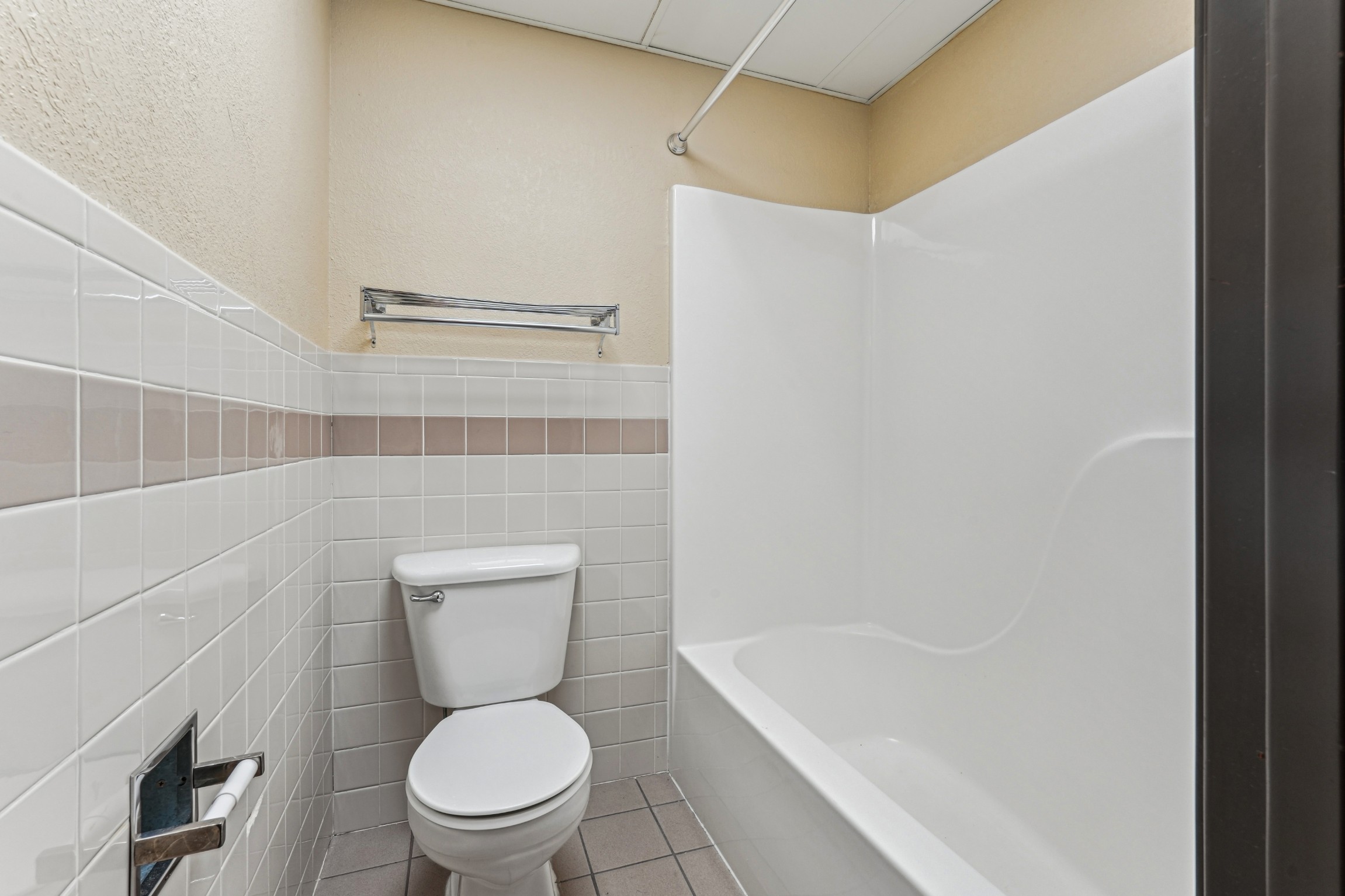 Bathroom with full tub shower combination at The House