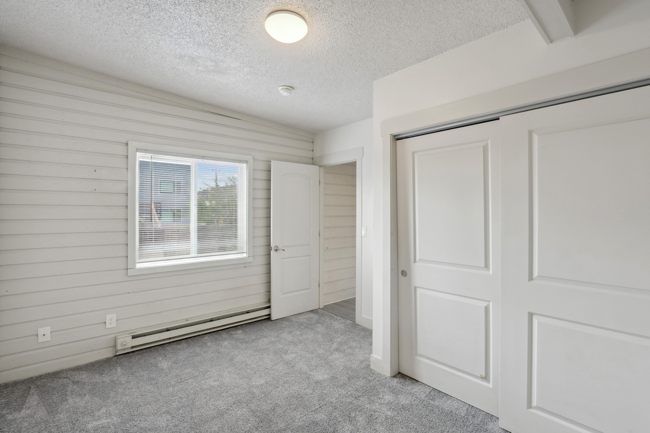 Bedroom with large closet and plush carpeting at Flats on 2nd