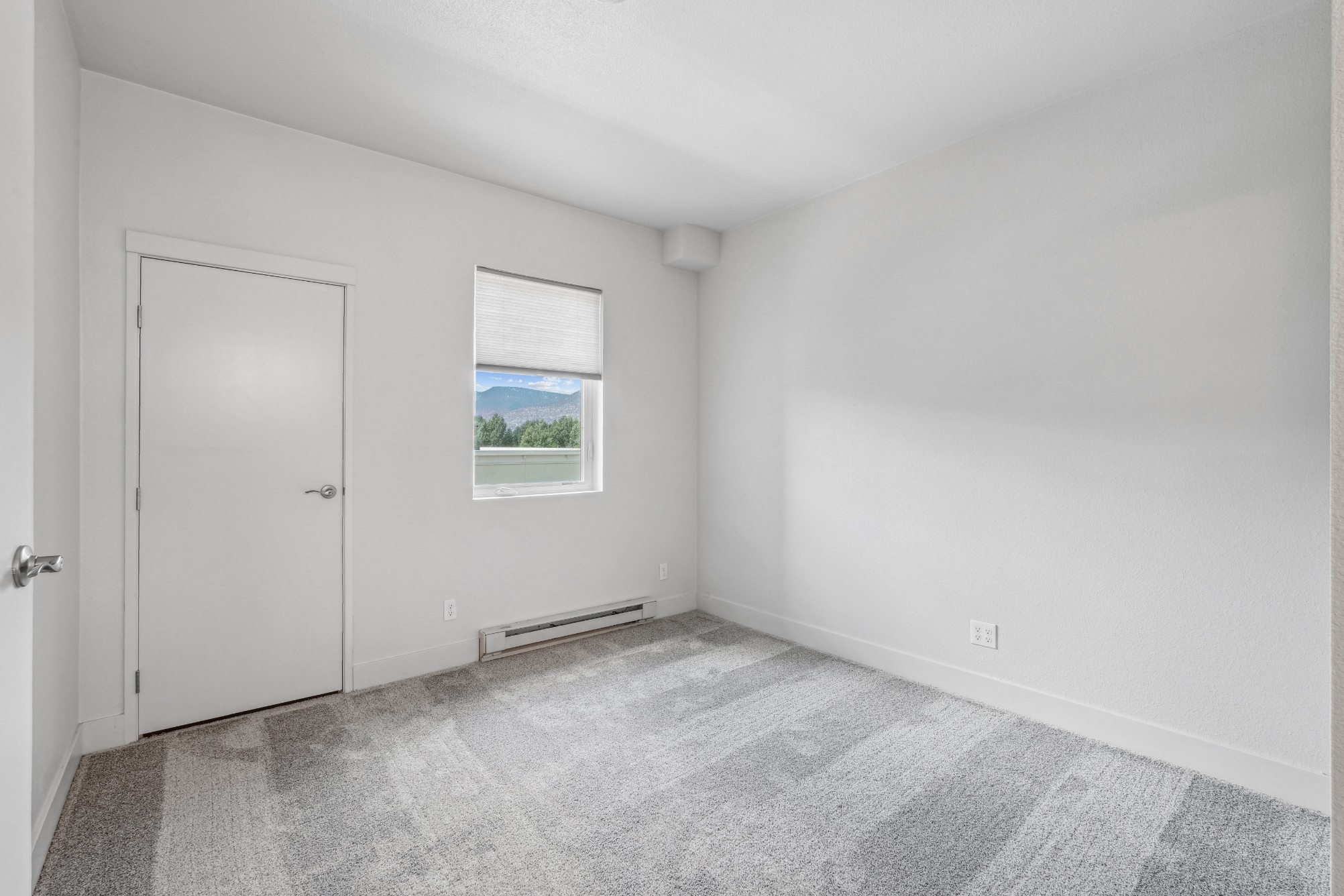 Bedroom with plush carpeting at Red Table Apartments