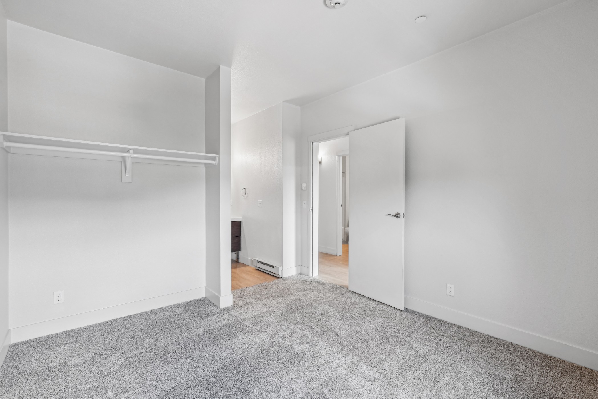 Carpeted bedroom at Red Table Apartments