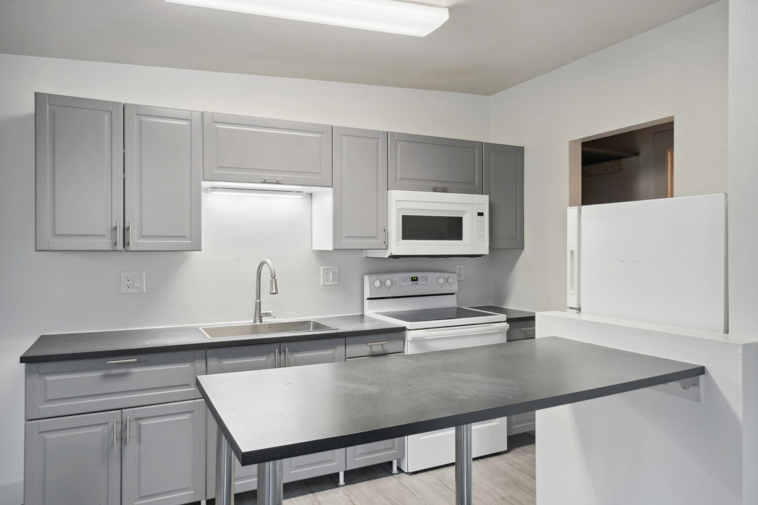 Fully equipped kitchen at Flats on 2nd scaled