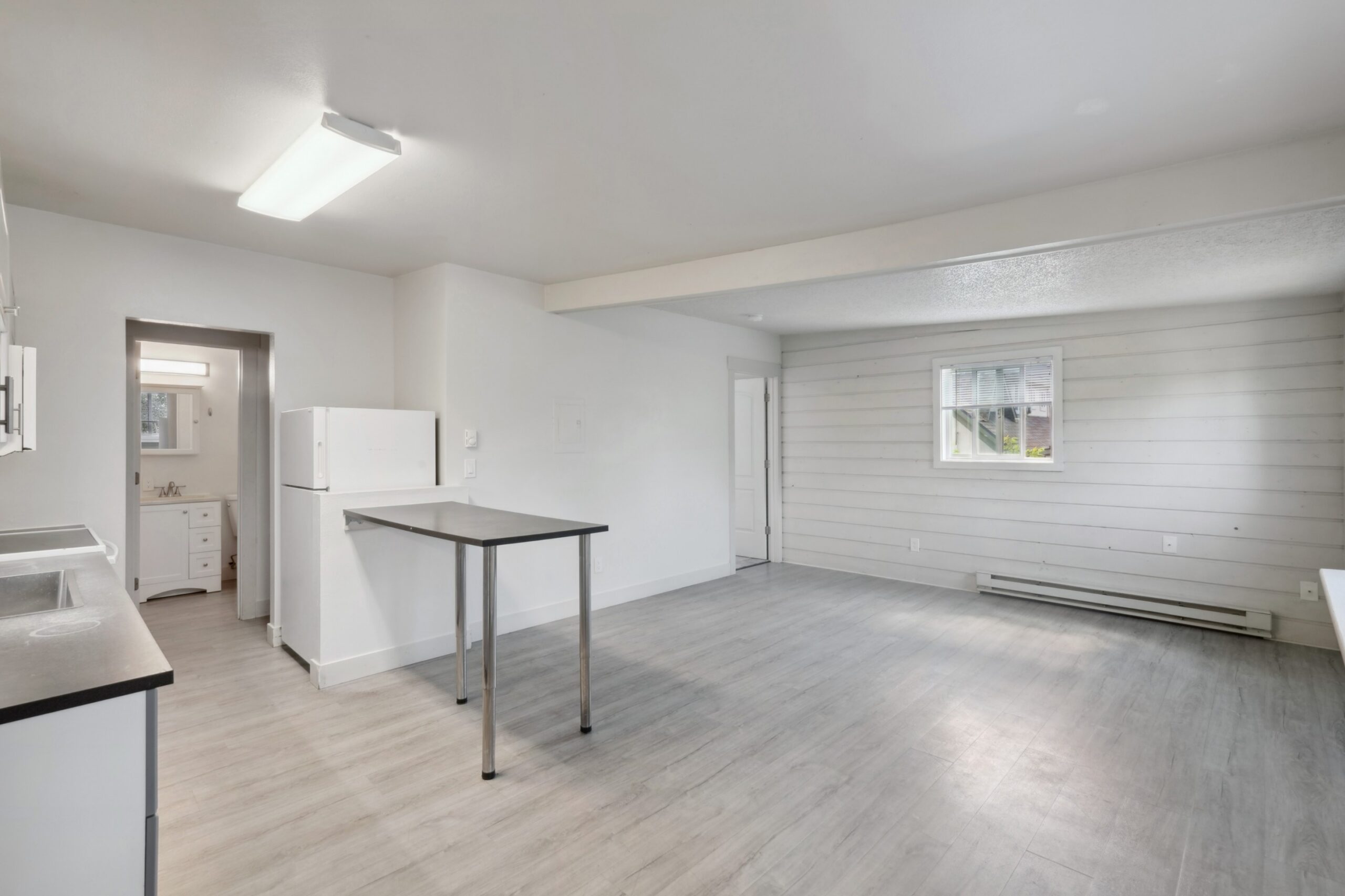 Kitchen and living area of an apartment at Flats on 2nd scaled