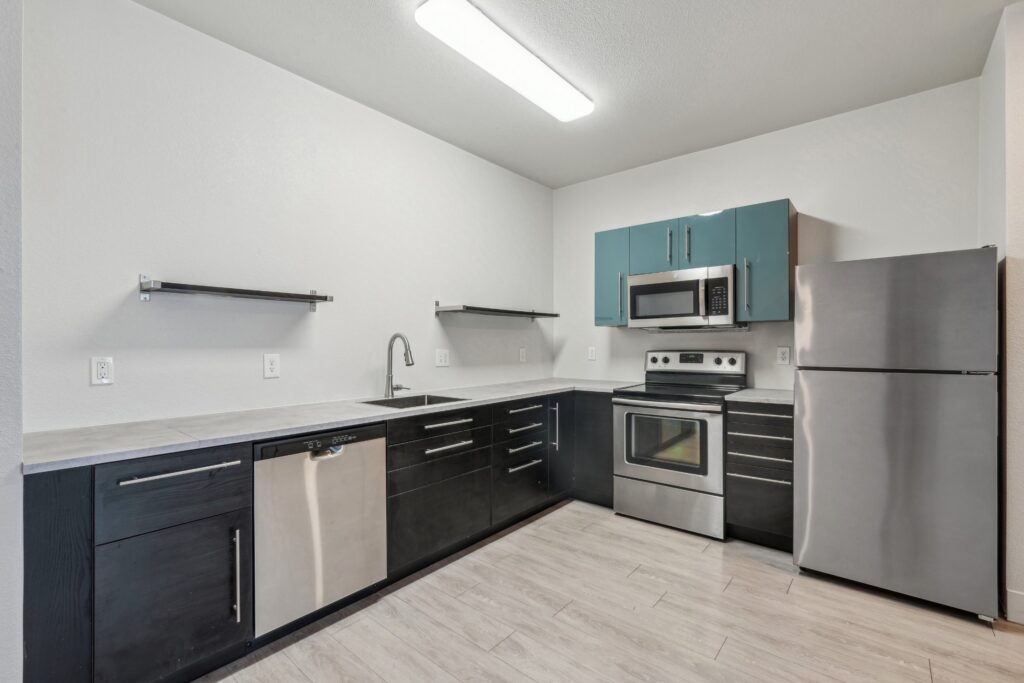 Kitchen with stainless steel appliances at Red Table Apartments