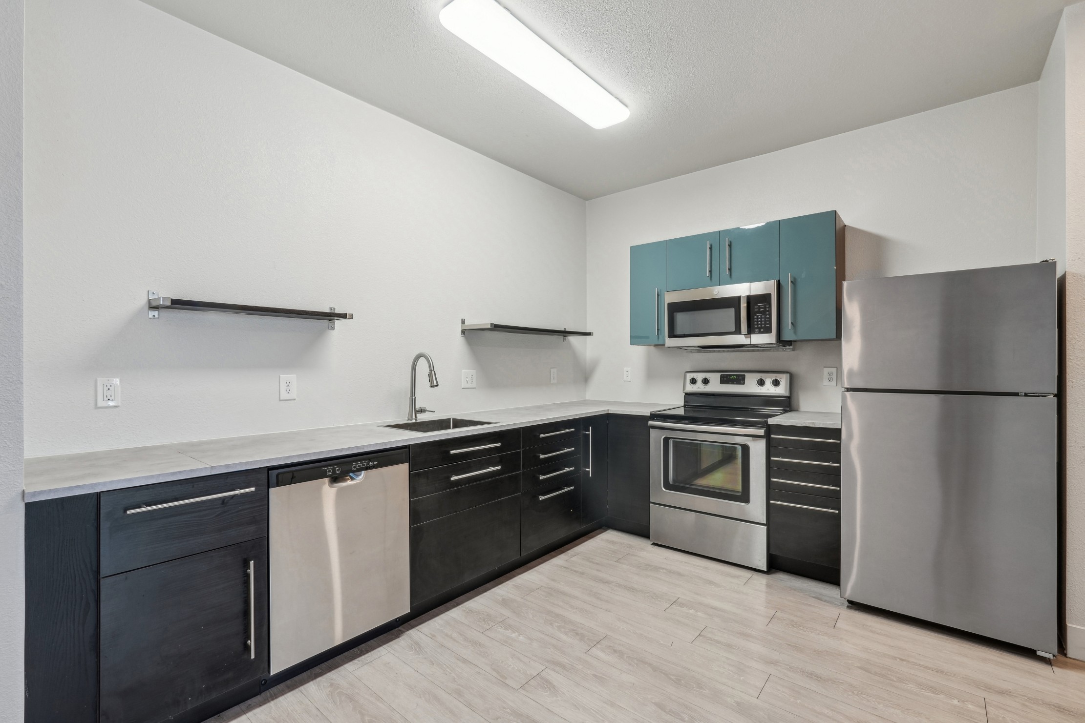 Kitchen with stainless steel appliances at Red Table Apartments