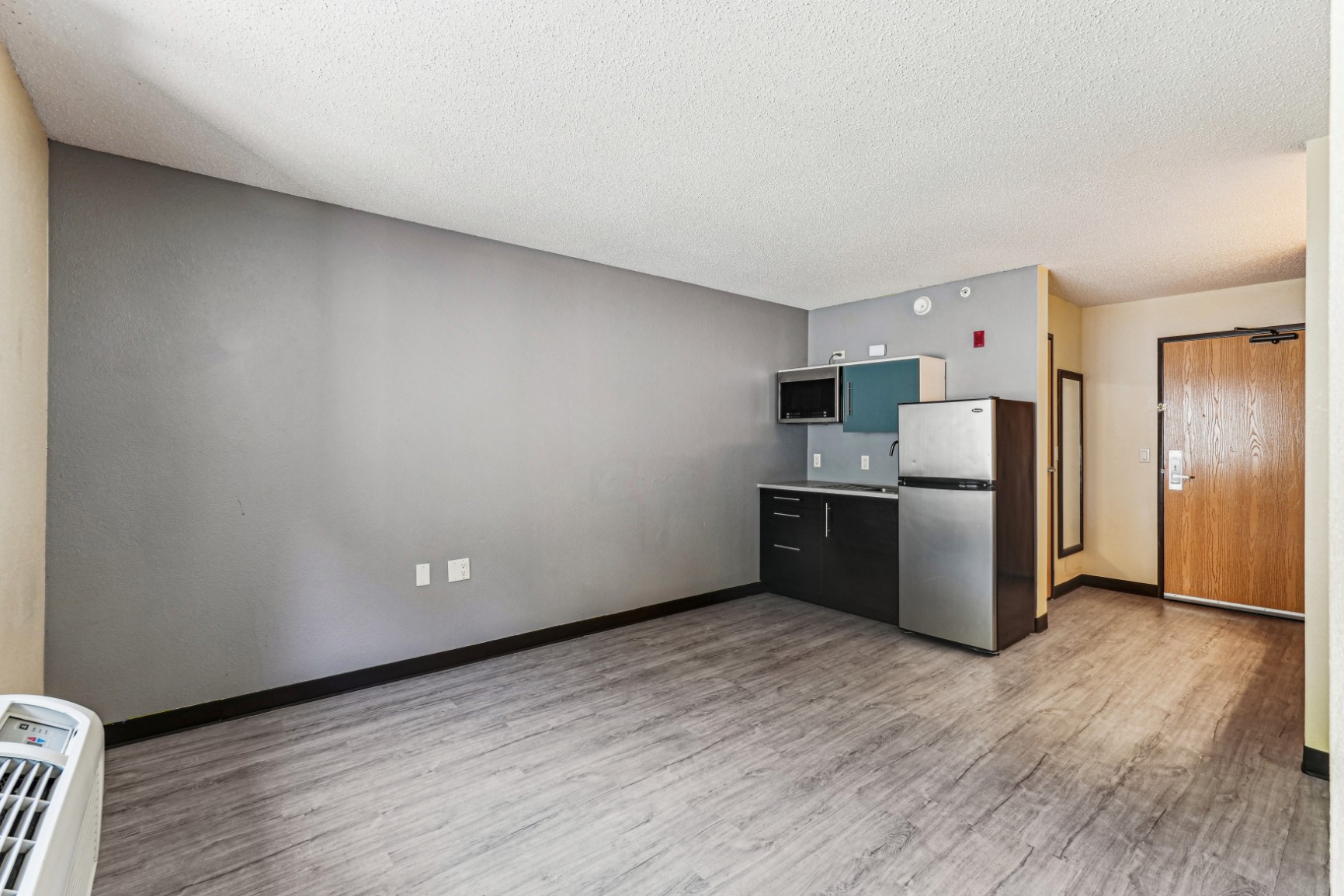 Living room and kitchenette in an apartment at The House