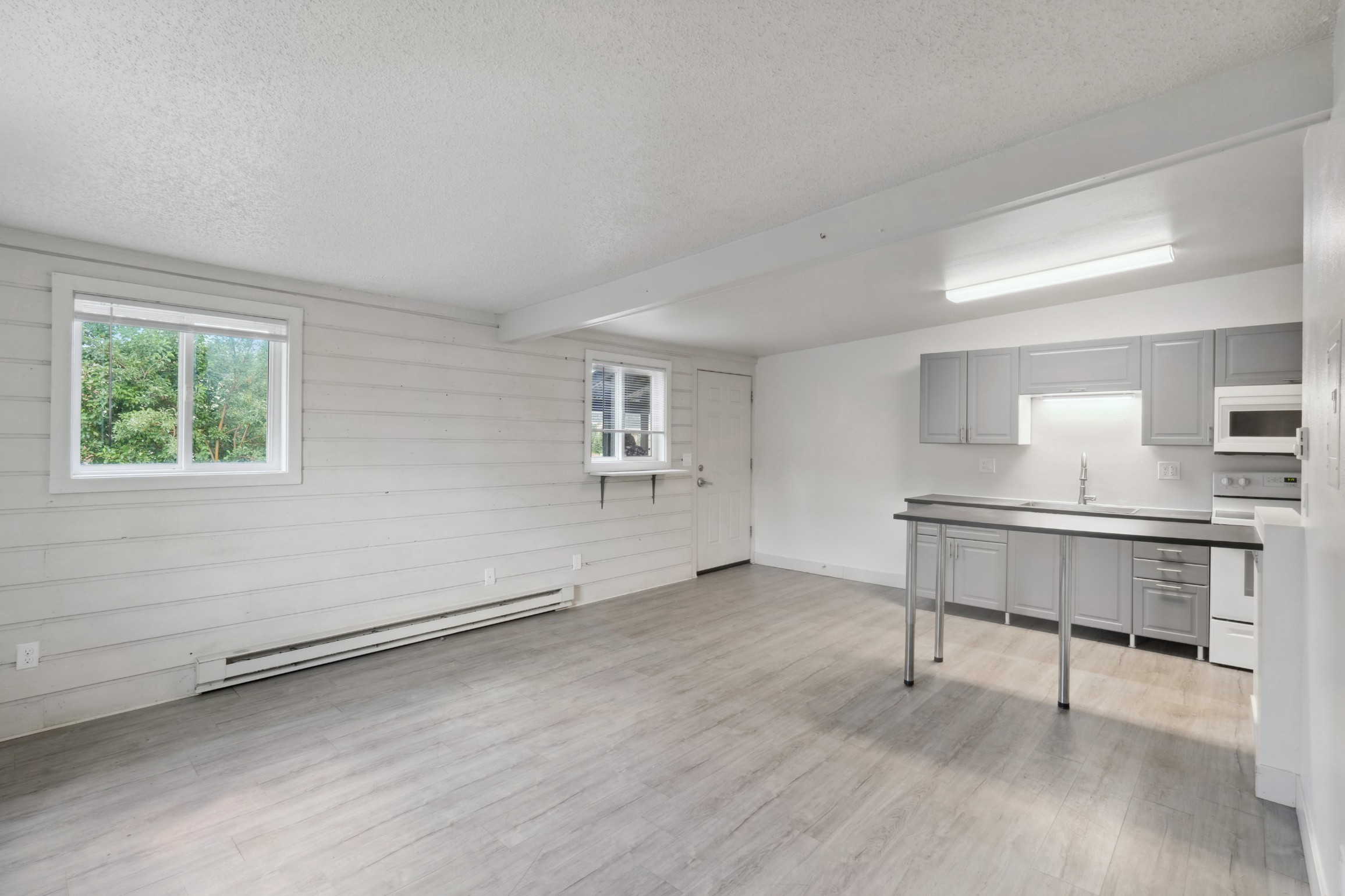 Open kitchen and living room with brand new finishes at Flats on 2nd