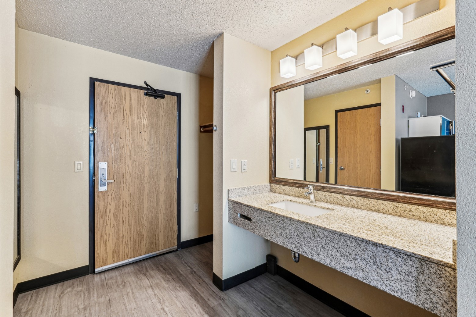 Sink and oversized vanity mirror in an apartment at The House