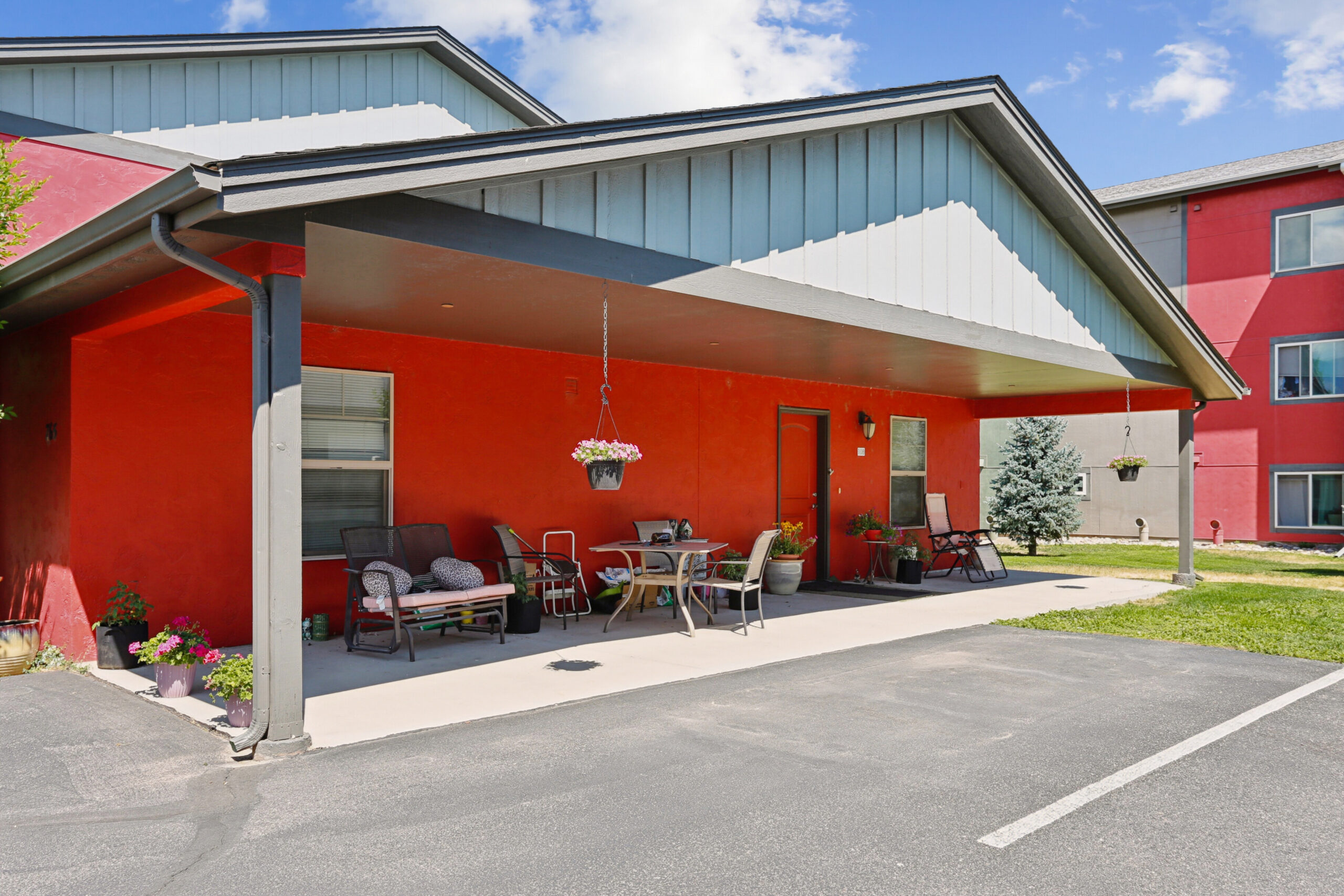 Covered patio seating of an apartment building at Red Table