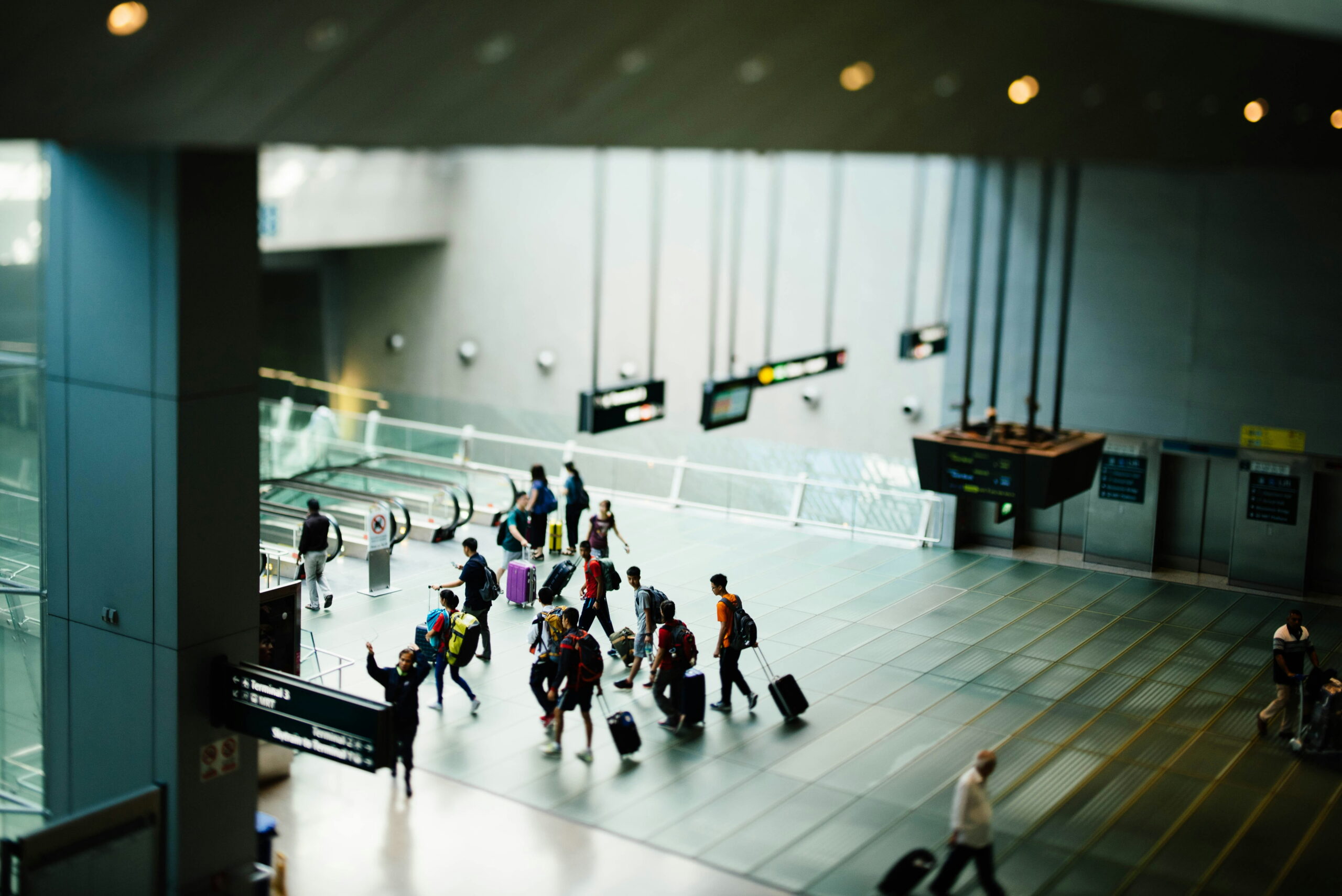 Busy airport terminal with travelers.