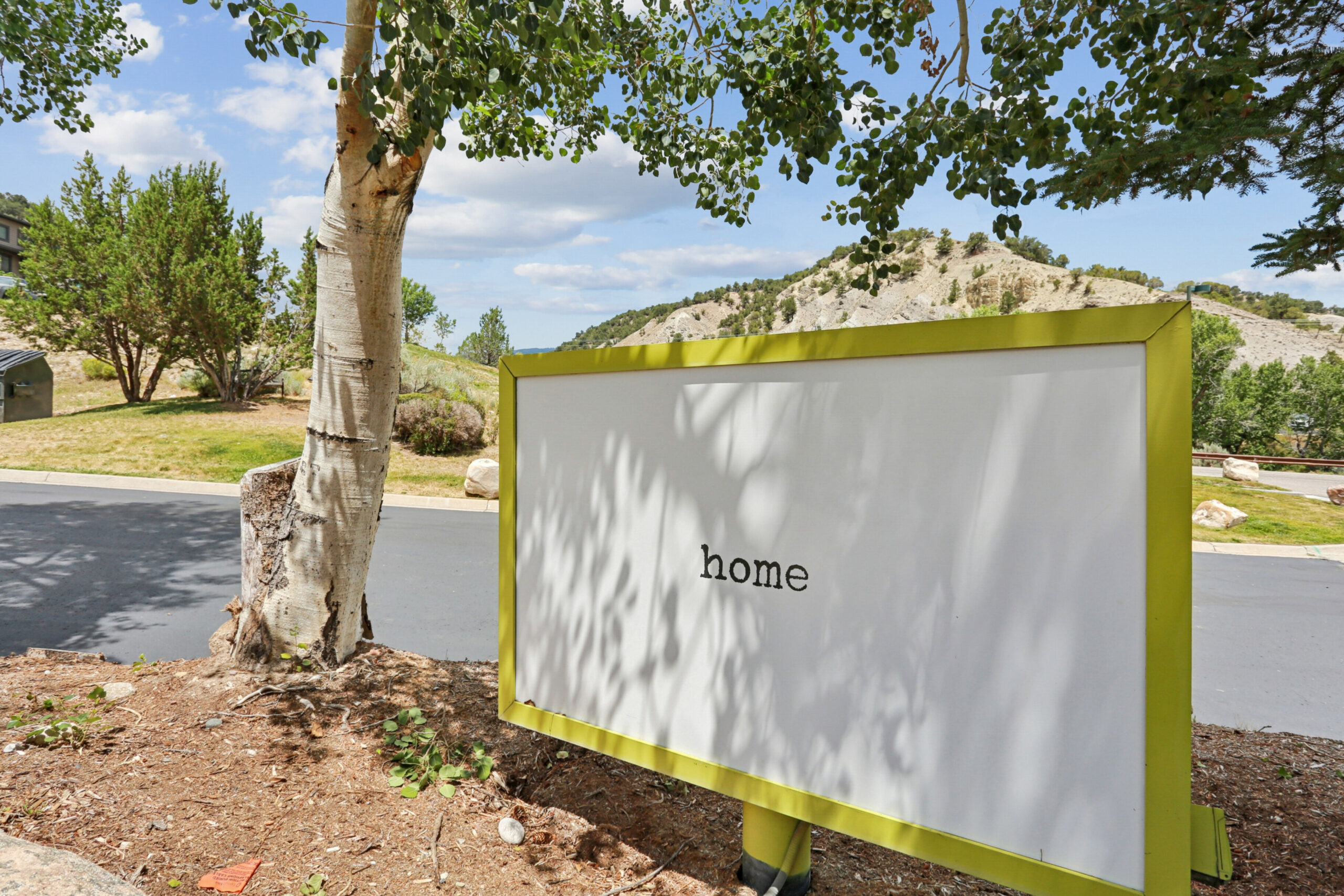 Outdoor 'home' sign at the entrance to The House apartments